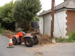 A quad bike being used to muck away dirt from an excavation
